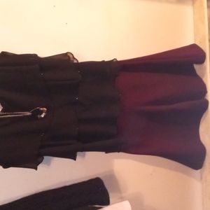 A beautiful black dress shirt with a necklace and a skirt comes as a set you can